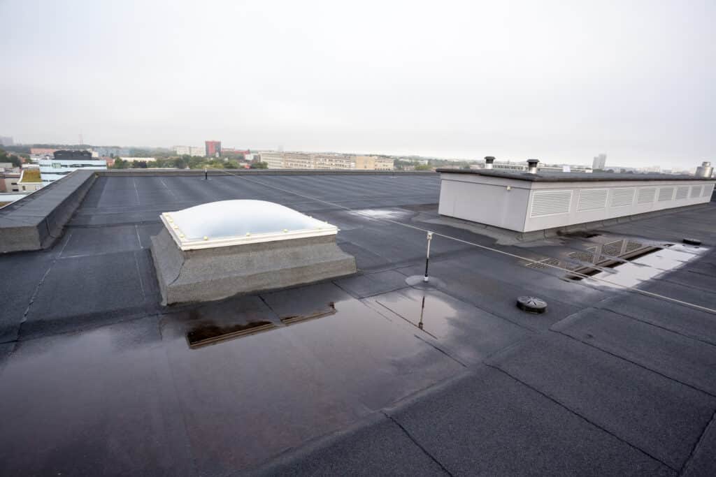 Inspection Gaps That Could Void Your Roof Warranty 2 commercial-roof-after-rain